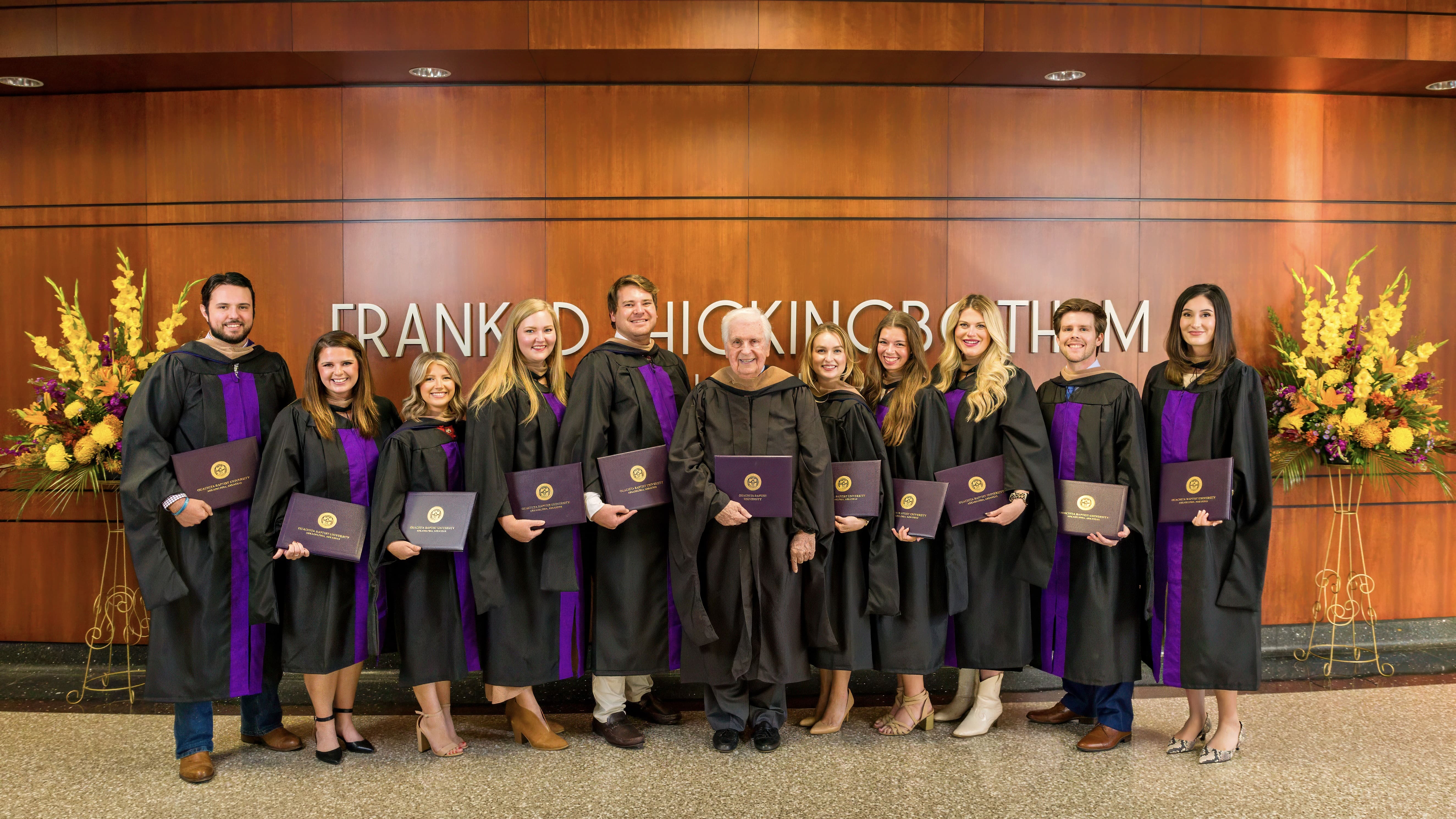 Ouachita Baptist University's first MBA graduates with Frank Hickingbotham