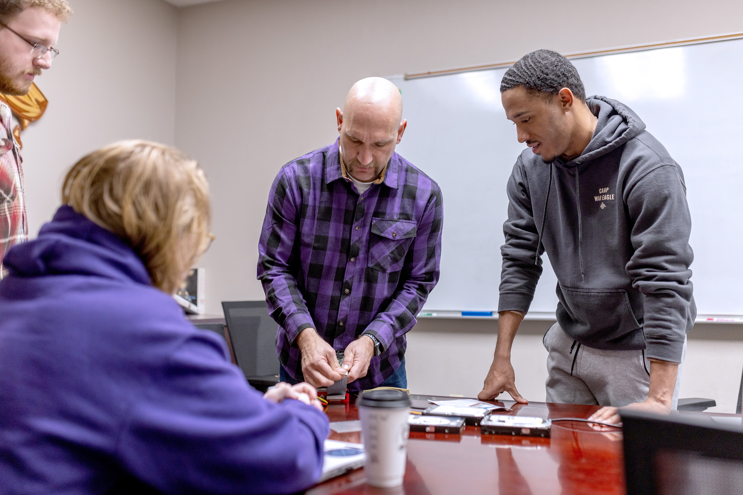 Scott Anderson, instructor of cybersecurity, with students